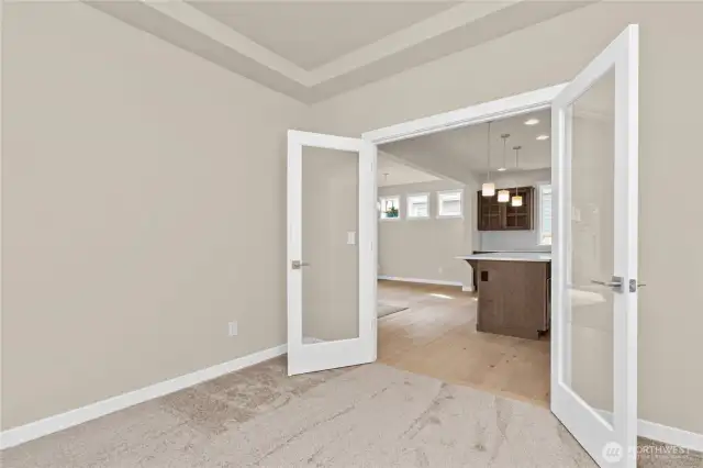 Double glass French doors lead to office/den in the heart of the main floor.