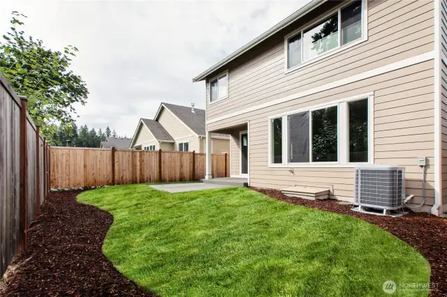 Backyard is landscaped and fully fenced with a patio.