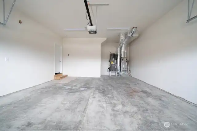 Double car garage is drywalled and includes standard garage door opener.