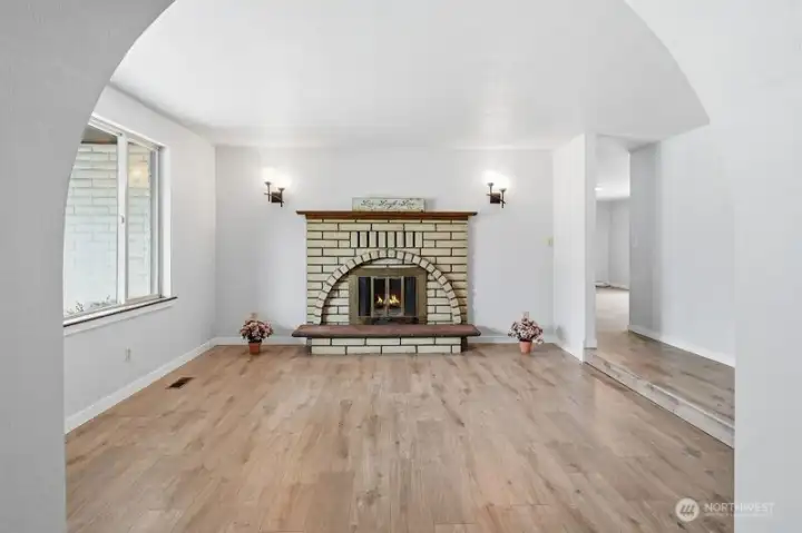 Notice the lovely softly rounded entry to the living room and the newer vinyl plank flooring...bring your furniture and make it your own style!