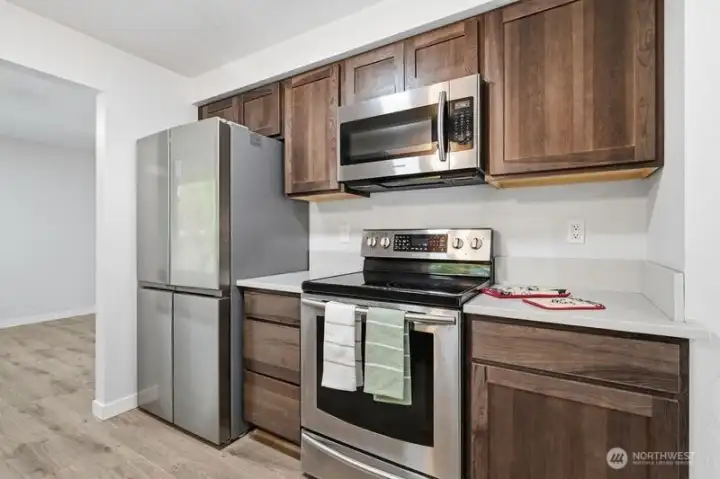 Newer stainless steel refrigerator and stainless appliances make this kitchen pop!
