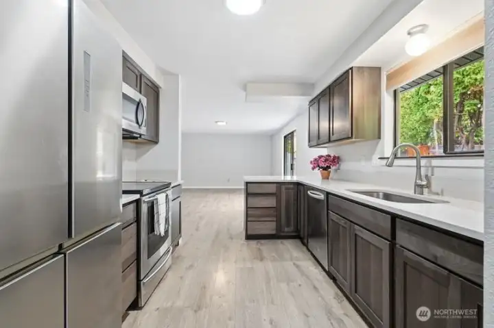 Kitchen looking into family room area, slider off to right goes out to lovely back patio area
