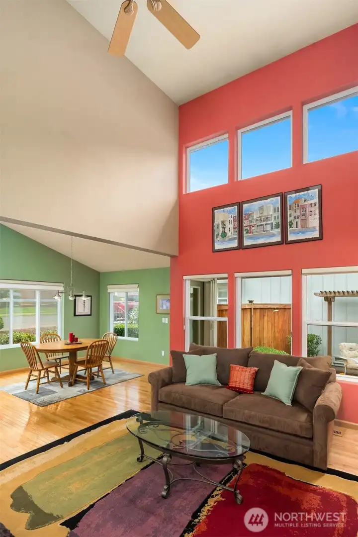 Vaulted Ceiling in Living Room. 3 Windows above couch have Roll Shutters