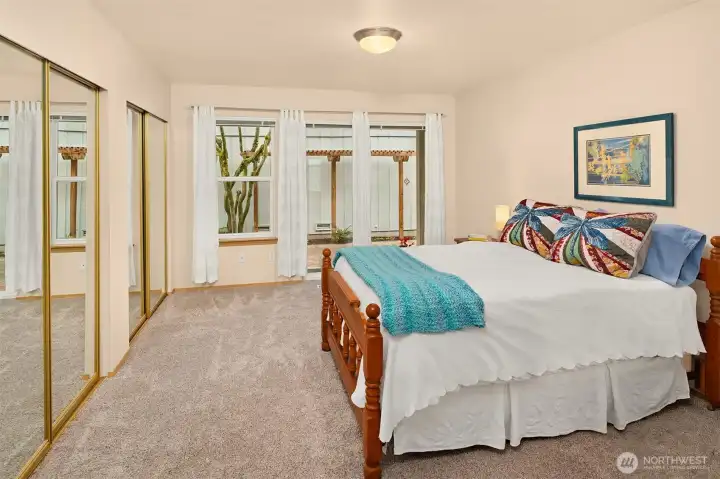 Primary Ensuite on Main Floor with 2 Double Closets and Access to Patio thru Slider