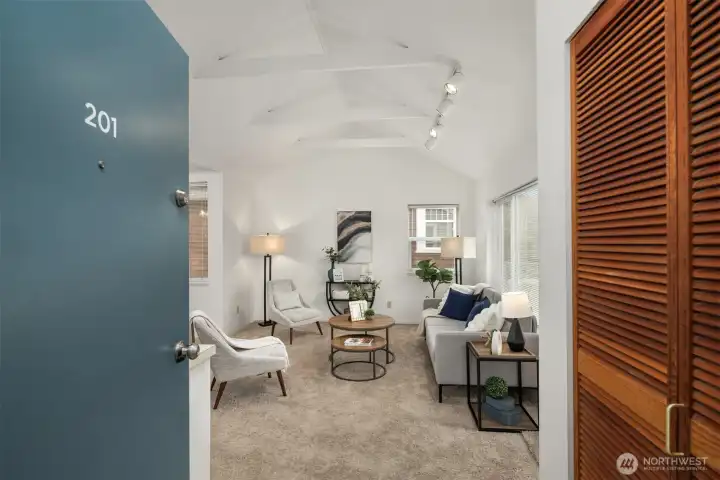 Inviting entry opens to sunlit family room with vaulted ceiling