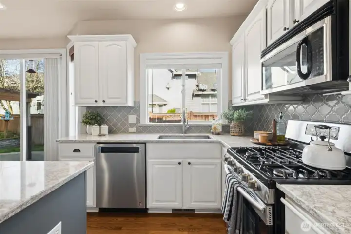 Expansive counters offer plenty of room for cooking, baking, and gathering. Open sightlines keep the kitchen connected to the rest of the home. It’s a workspace that feels both spacious and inviting. Enjoy a Gas cooktop and Stainless steel appliances.