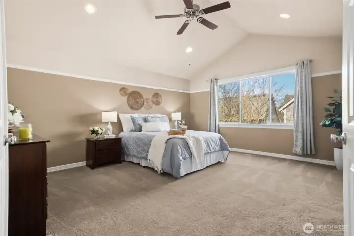 Upstairs the primary suite is a true retreat with vaulted ceilings and abundant natural light. The spacious design creates a peaceful, private escape. It’s a room that feels luxurious every day with soft, neutral carpet underfoot. A central vacuum system adds convenience throughout the home.