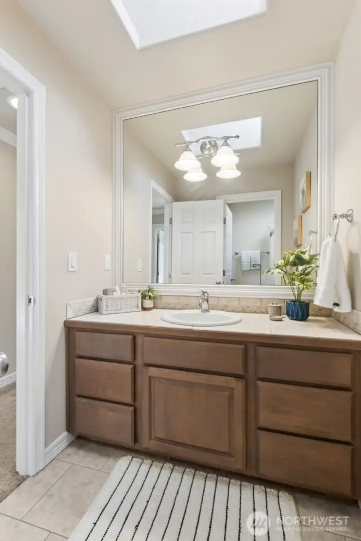 The upstairs Full guest bath offers a separate W/C for flexibility.