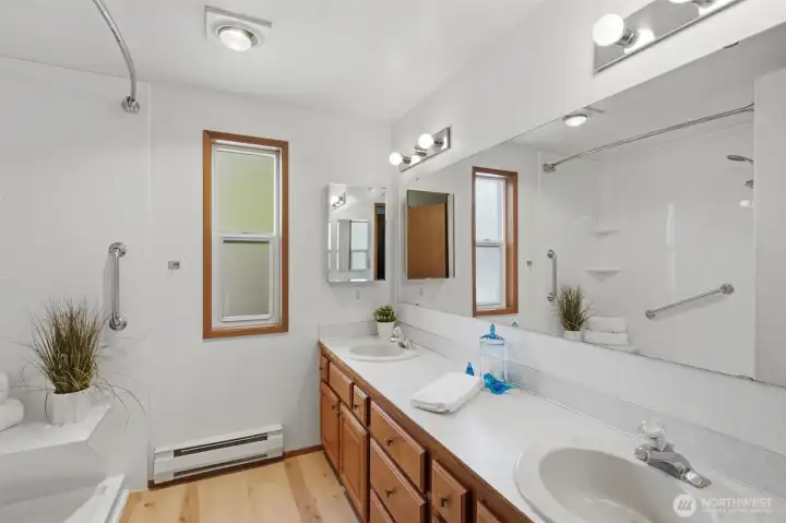 Primary bathroom with dual sinks and walk in shower