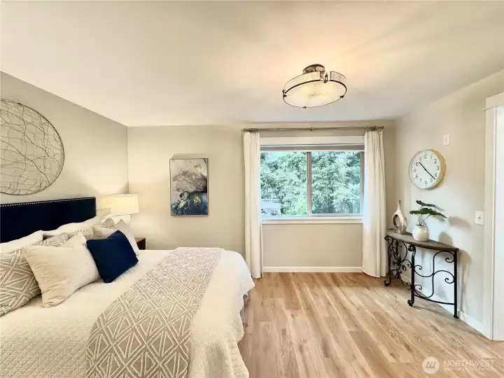 Upper level primary suite with newly refinished hardwood flooring, new light fixtures, new millwork & new window treatments. Upper level primary suite with newly refinished hardwood flooring, new light fixtures, new millwork & new window treatments.