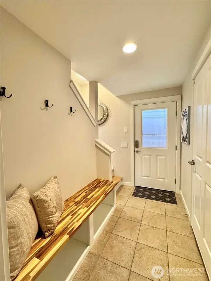 Lowever-level entry mudroom with new bench, flooring, paint. Lowever-level entry mudroom with new bench, flooring, paint.