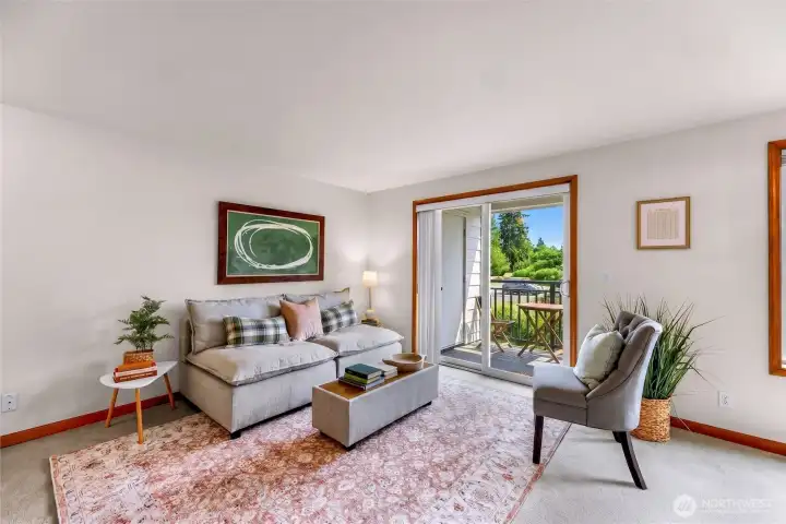 Bright living room with sliding glass doors, private balcony access