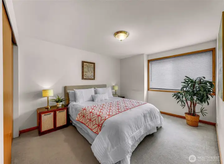 Bedroom with large picture window and closet