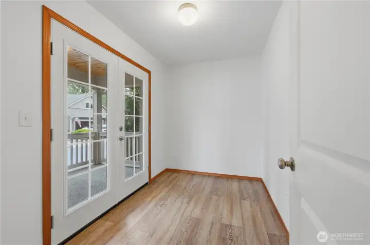 Den/office with french doors to the covered front porch