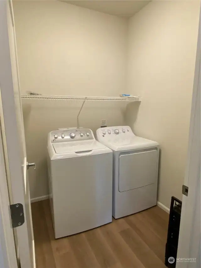 Laundry room with included washer dryer.