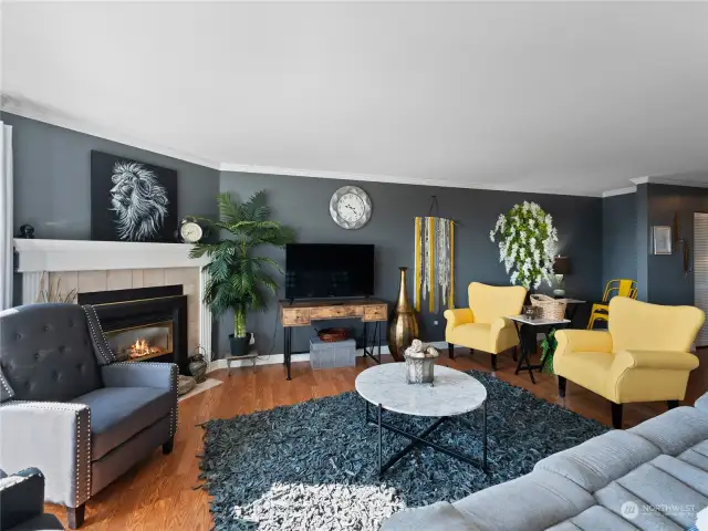 Living room with freshly painted walls, trim and ceiling, LVP flooring and cozy gas fireplace! Fully furnished and ready for you to move right in!