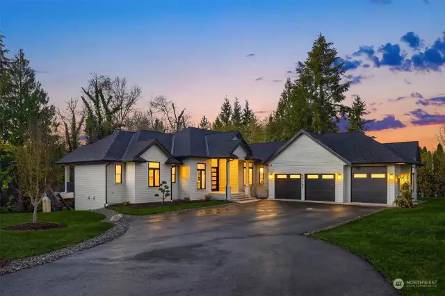 Private at the end of the drive, the home looks inviting surrounded by low maintenance 0.5-acre grounds blending meticulous lawns and natural contours.