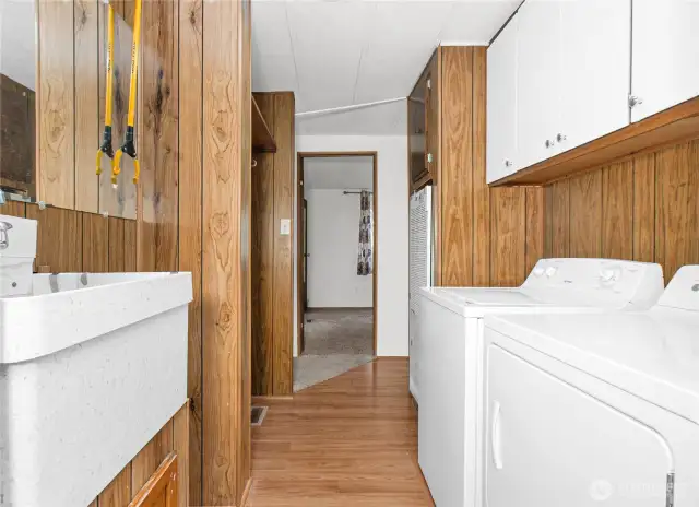 Laundry room has a sink to clean up from outside. Washer and dryer stay.