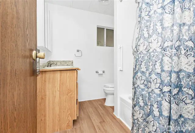 Full bath has nice laminate flooring.