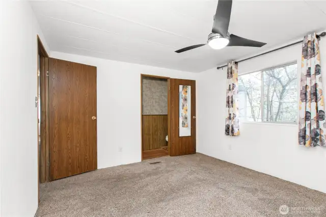 View of primary bedroom with 1/2 bath