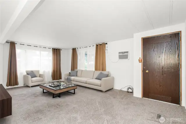 Spacious living room with nice carpet.  Virtually staged Living room