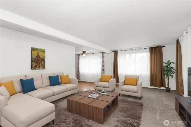 ge windows to let the sun it.  Situated off of a nice sunroom.  Virtually staged. Living room