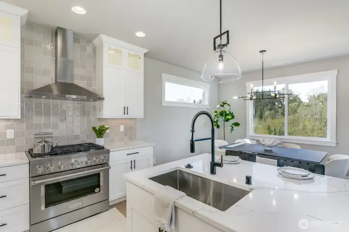 Commerical style Smart oven with gas cooktop. Photo is of the staged model, the same 2,958 sf floor plan as the listed home.  Colors vary.