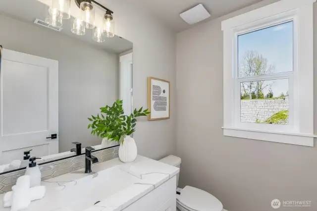 Powder bath on the main. Photo is of the staged model, the same 2,958 sf floor plan as the listed home.  Colors vary.