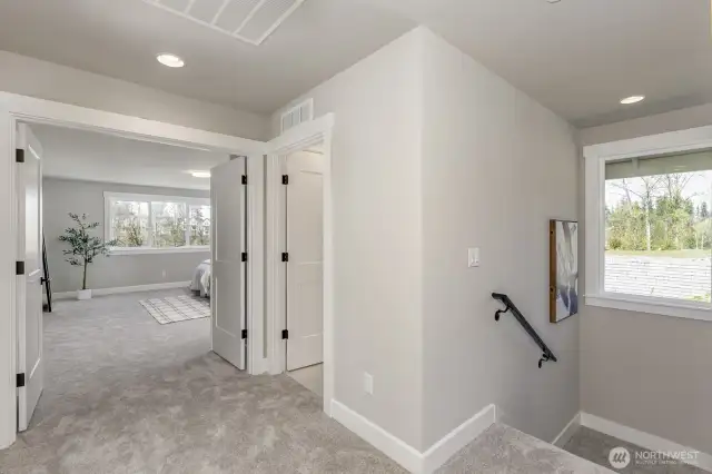 French doors lead to Primary Ensuite. Photo is of the staged model, the same 2,958 sf floor plan as the listed home.  Colors vary.