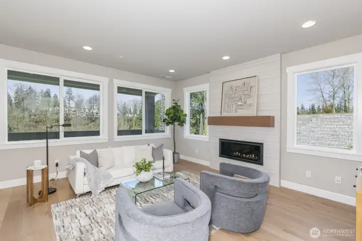 Light-filled Living Room with beautiful view. Photo is of the staged model. Colors vary.