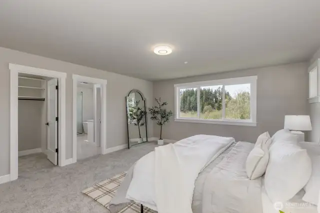 Large Primary Ensuite offers 2 custom walk-in closets. Photo is of the staged model, the same 2,958 sf floor plan as the listed home.  Colors vary.