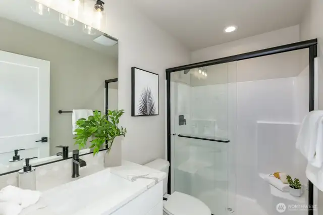 Daylight basement guest bathroom. Photo is of the staged model, the same 2,958 sf floor plan as the listed home.  Colors vary.