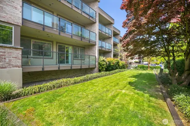 Main floor unit has a deck which overlooks luscious green landscaping. City views from here, too.