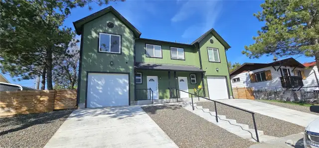 Large pine trees set this property apart from typical row house duplexes