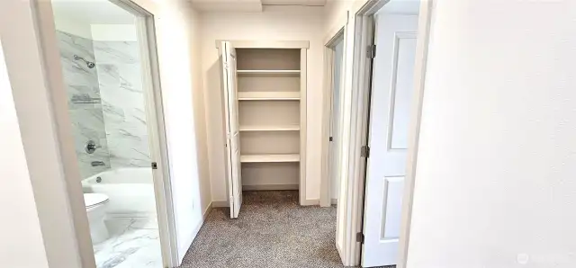 Top of landing with linen closet and main bathroom