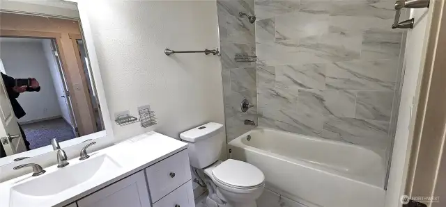 Main bath with tiled tub shower surround