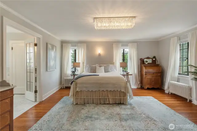 A crystal chandelier graces the large primary suite.