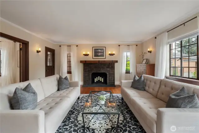 Spacious living room centers on restored wood burning fireplace