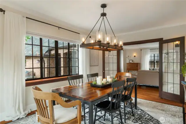 Leaded glass French doors lead to the formal dining room