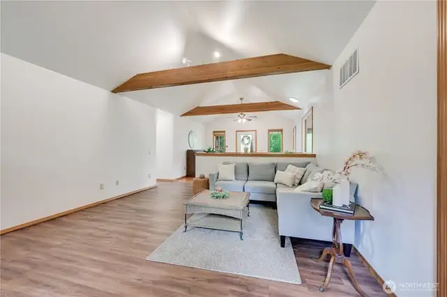 Living room.  Notice how the custom beams highlight the vaulted ceiling