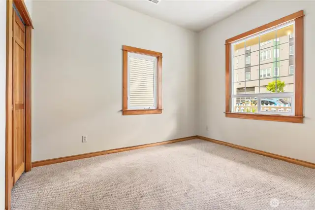 Main floor bedroom with abundant natural light and generous closet space.