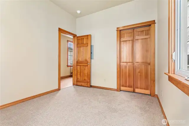 Bedroom has fresh new carpet and high ceilings.