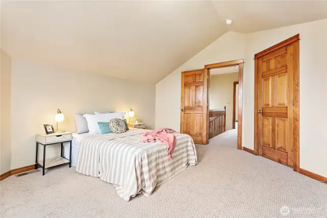 Enjoy vaulted ceilings and fresh paint in this spacious, well-laid-out bedroom.