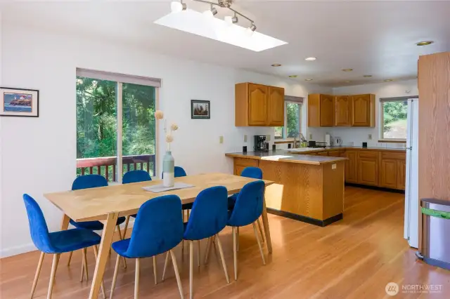 Dining and kitchen flow seamlessly together, creating a warm, open space for gathering and entertaining