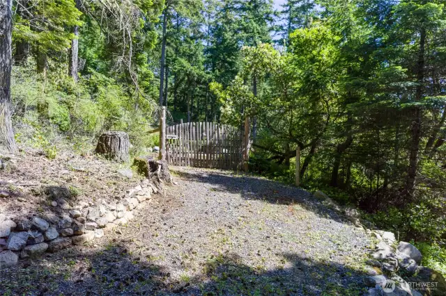 This charming path guides you to a gated, fenced garden—perfect for peaceful moments or cultivating your favorite blooms