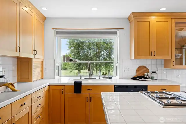 The counter tops are composite except the island which has tile to match that of the backsplash.