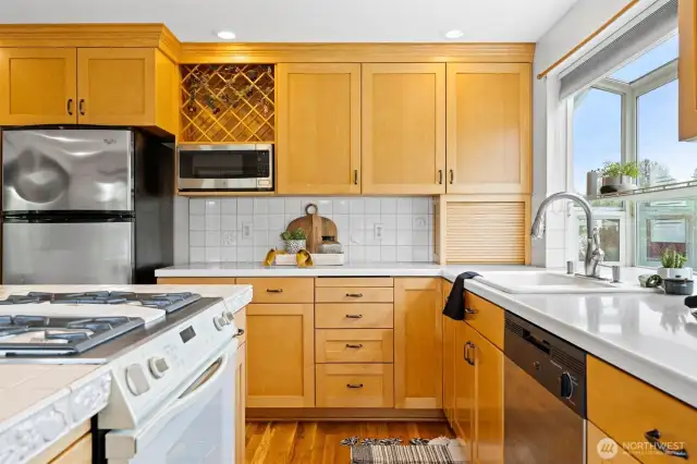 The kitchen has a wine rack above the microwave and an appliance garage with a tamboured door.