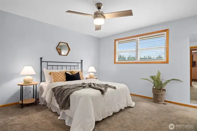 The primary suite is very spacious and looks out toward the front lawn.