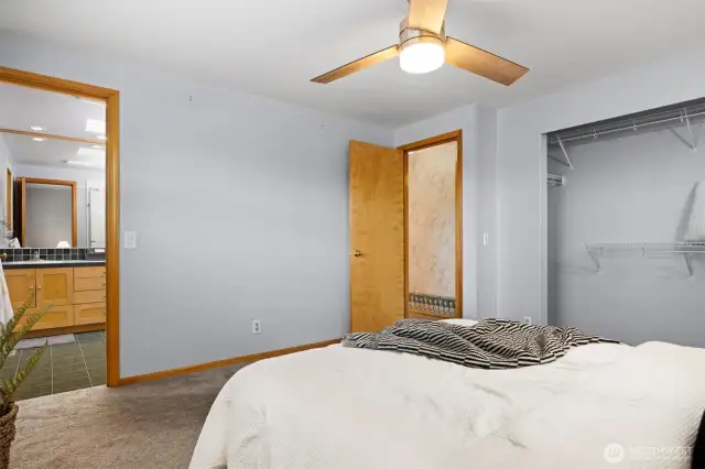 Looking toward the 3/4 bath off the primary bedroom with the closet and hallway across the room.