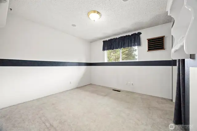 The third bedroom also looks out toward the rear yard and is very spacious.